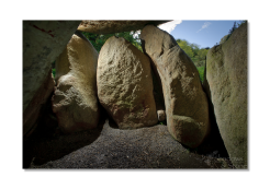 The structural stones lean heavily under the enormous weight of the capstone.