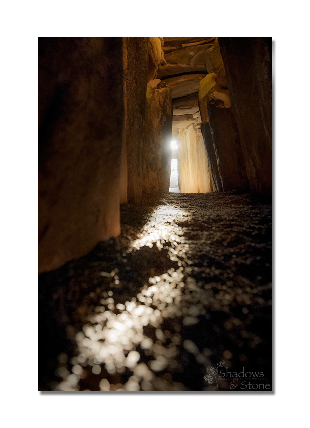 Winter Solstice sunrise shines through the roofbox above the door of Newgrange and along the passage floor